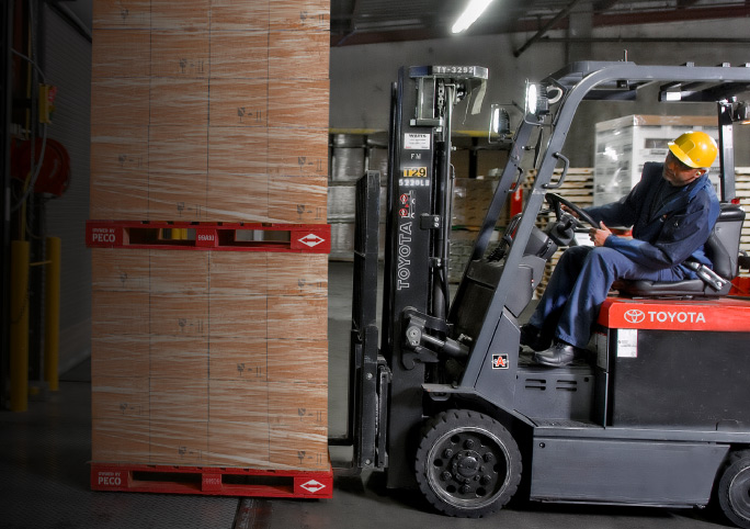 Mobile Banner for Home Page - Stacked of PECO Pallets on a folklift with two PECO workers.
